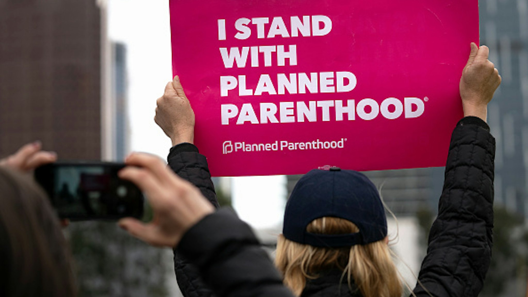 An activist seen holding a placard that says I Stand with Planned Parenthood during the protest.