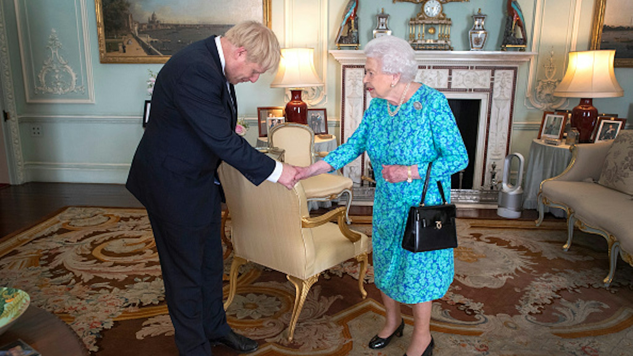 Queen Elizabeth II welcomes newly elected leader of the Conservative party, Boris Johnson during an audience where she invited him to become Prime Minister and form a new government in Buckingham Palace on July 24, 2019 in London, England.
