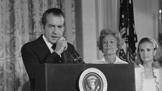 President Richard Nixon says an emotional farewell to his staff and cabinet in the East Room of the White House after resigning from office. His wife, Pat, and daughter Tricia are at right.