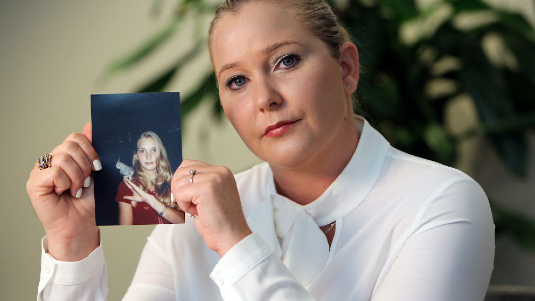 Virginia Roberts holds a photo of herself at age 16, when she says Palm Beach multimillionaire Jeffrey Epstein began abusing her sexually.