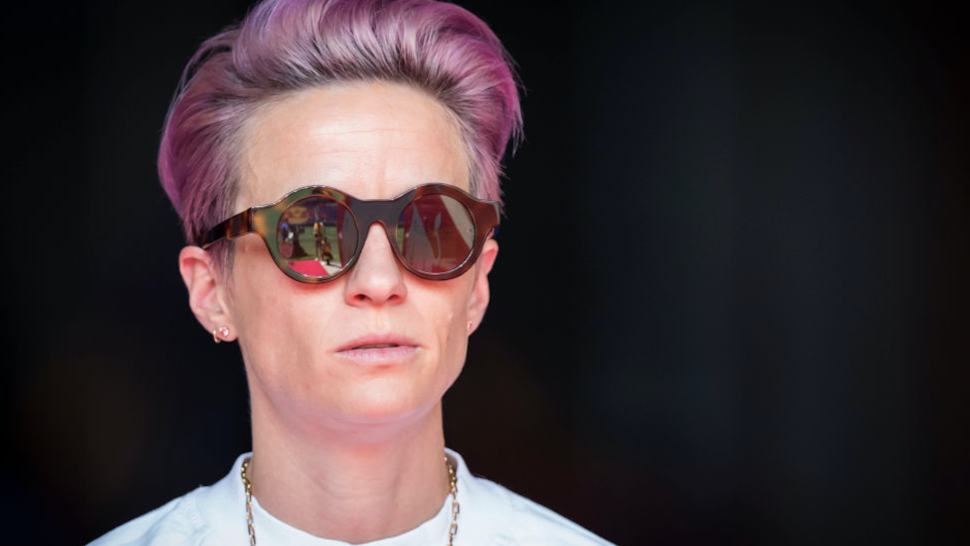 Megan Rapinoe #15 of Seattle Reign FC with pink hair and sunglasses stands in on the sideline due to an injury before the National Women's Soccer League match between Sky Blue F.C. and Seattle Reign F.C.. The match was held at Red Bull Arena on August 18,