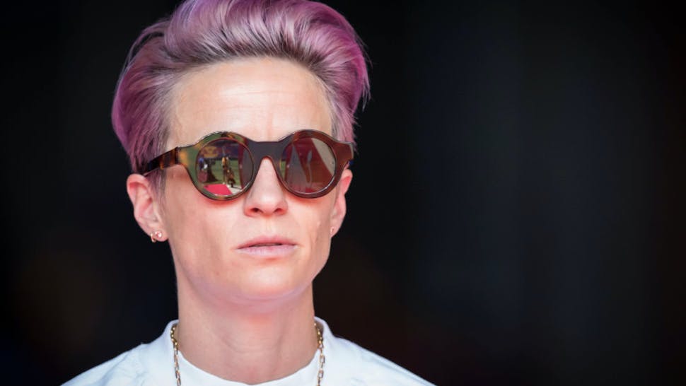 Purple Reign Over! 4 Megan Rapinoe #15 of Seattle Reign FC with pink hair and sunglasses stands in on the sideline due to an injury before the National Women's Soccer League match between Sky Blue F.C. and Seattle Reign F.C.. The match was held at Red Bull Arena on August 18,
