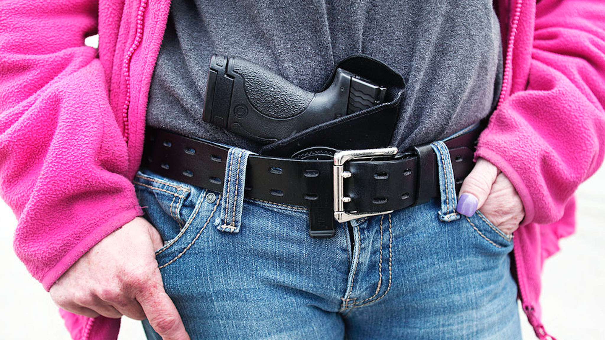 Gloria Lincoln-Thompson of Garden City, Michigan carries her Smith & Wesson Shield 9mm pistol in her belt while participating in a rally and march supporting Michigan's Open Carry law April 27, 2014 in Romulus, Michigan.