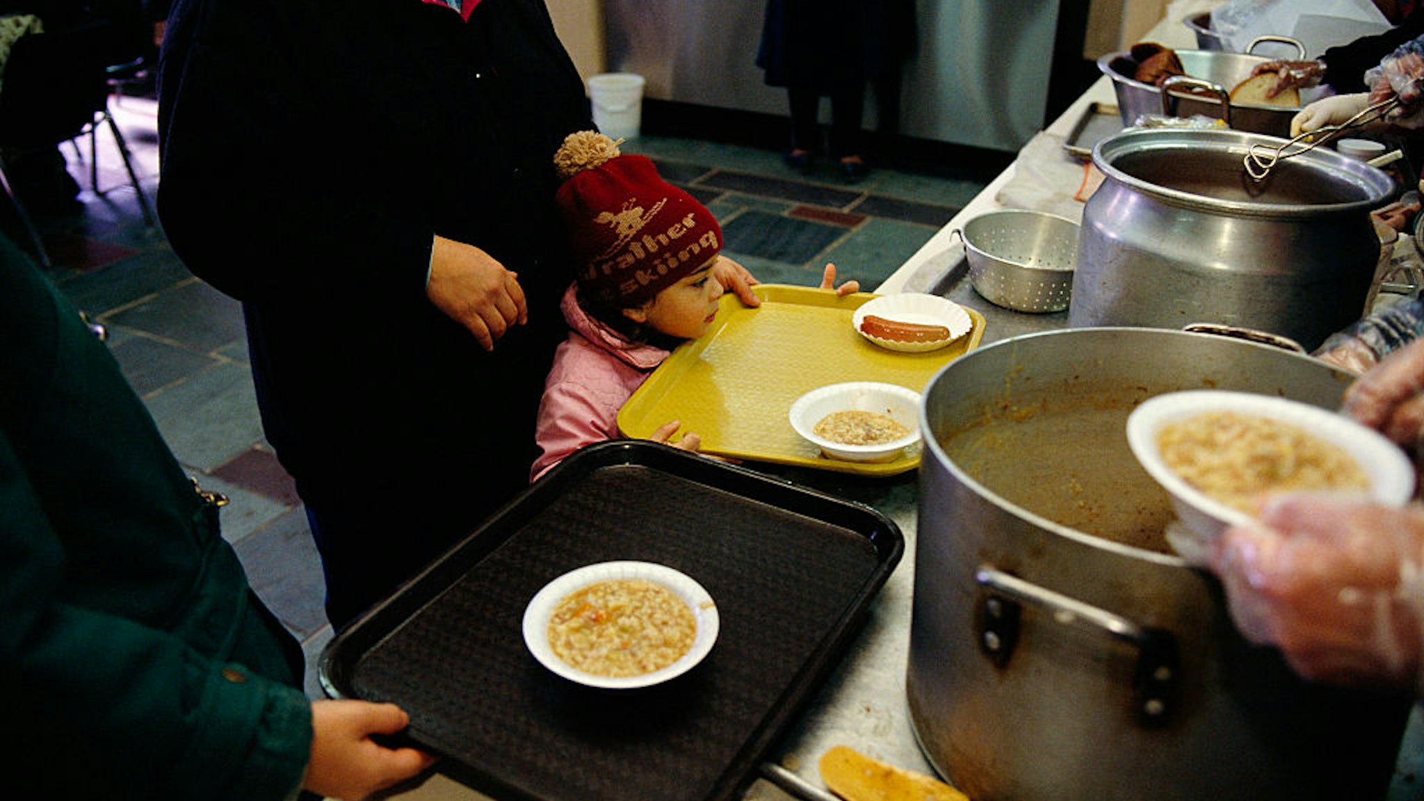Volunteers with St. John's Bread and Life Soup Kitchen feed the poor and the homeless in New York City. (