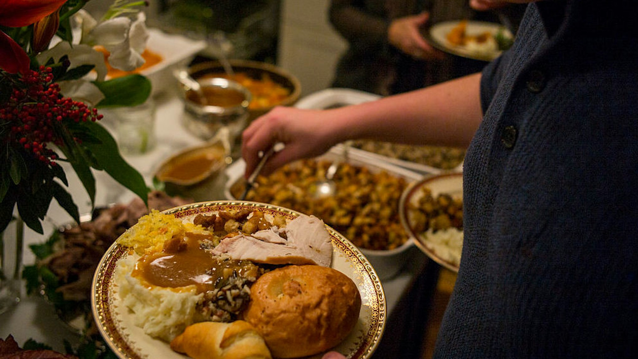 Unidentified diners serve themselves food at a traditional Thanksgiving Day family gathering in Bloomfield Hills, Michigan on November 26, 2015.