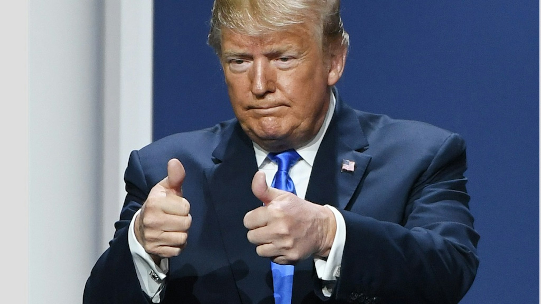 Trump gives thumbs up.