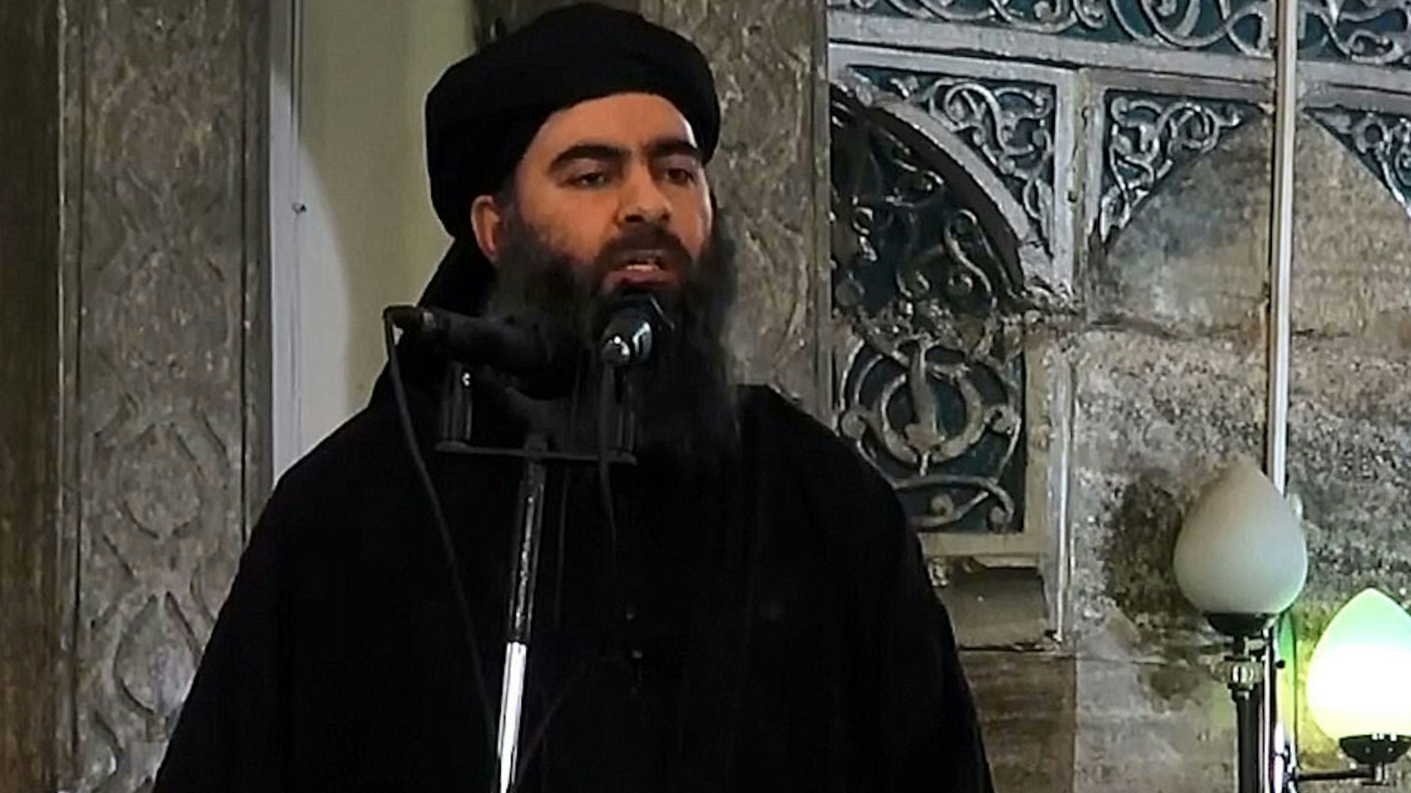An image grab taken from a video released on July 5, 2014 by Al-Furqan Media shows alleged Islamic State of Iraq and the Levant (ISIL) leader Abu Bakr al-Baghdadi preaching during Friday prayer at a mosque in Mosul.(Photo by Al-Furqan Media/Anadolu Agency/Getty Images)