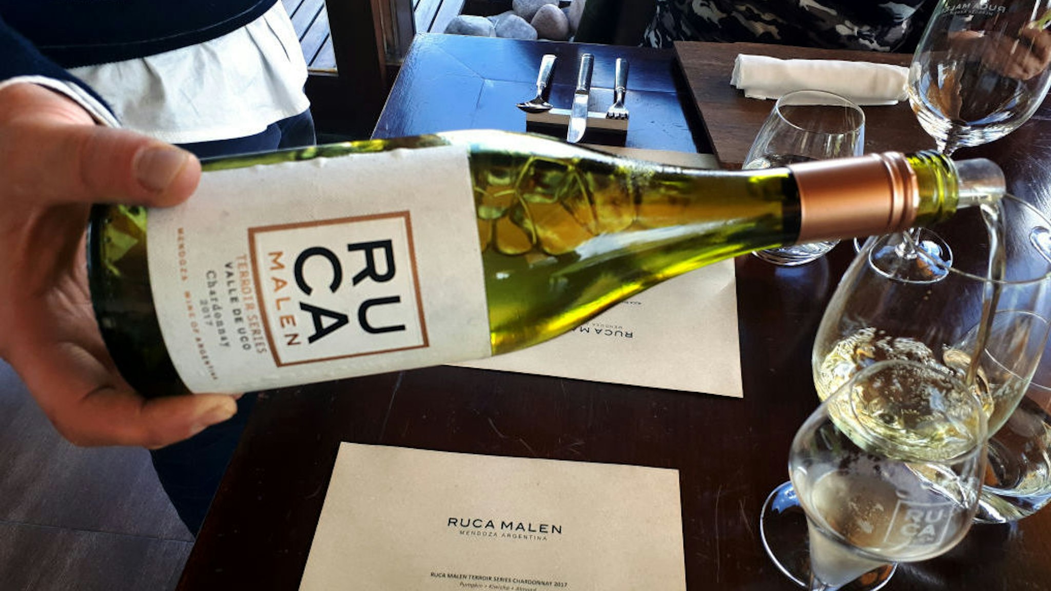 Bodega Ruca Malen's Terroir series Chardonnay 2017 vintage is served at the start of a seven-course tasting menu at the winery's restaurant on March 28, 2019 in the Luj√°n de Cuyo district of Mendoza province, Argentina. Ruca Malen winery was established in 1998 and opened its on-site gourmet restaurant in 2004, surrounded by vineyards and with a view of the nearby Andes mountains. Under head chef Lucas Bustos, the restaurant's menu is dedicated to locally sourced produce and pairs every course with a different Ruca Malen wine. According to government data, increasing numbers of foreign tourists are flocking to the iconic wine-producing province of Mendoza and its award-winning wineries attracted by a cheaper devalued Peso and acclaimed wines at bargain prices in the wake of Argentina's latest economic meltdown. (Photo by David Silverman/Getty Images)