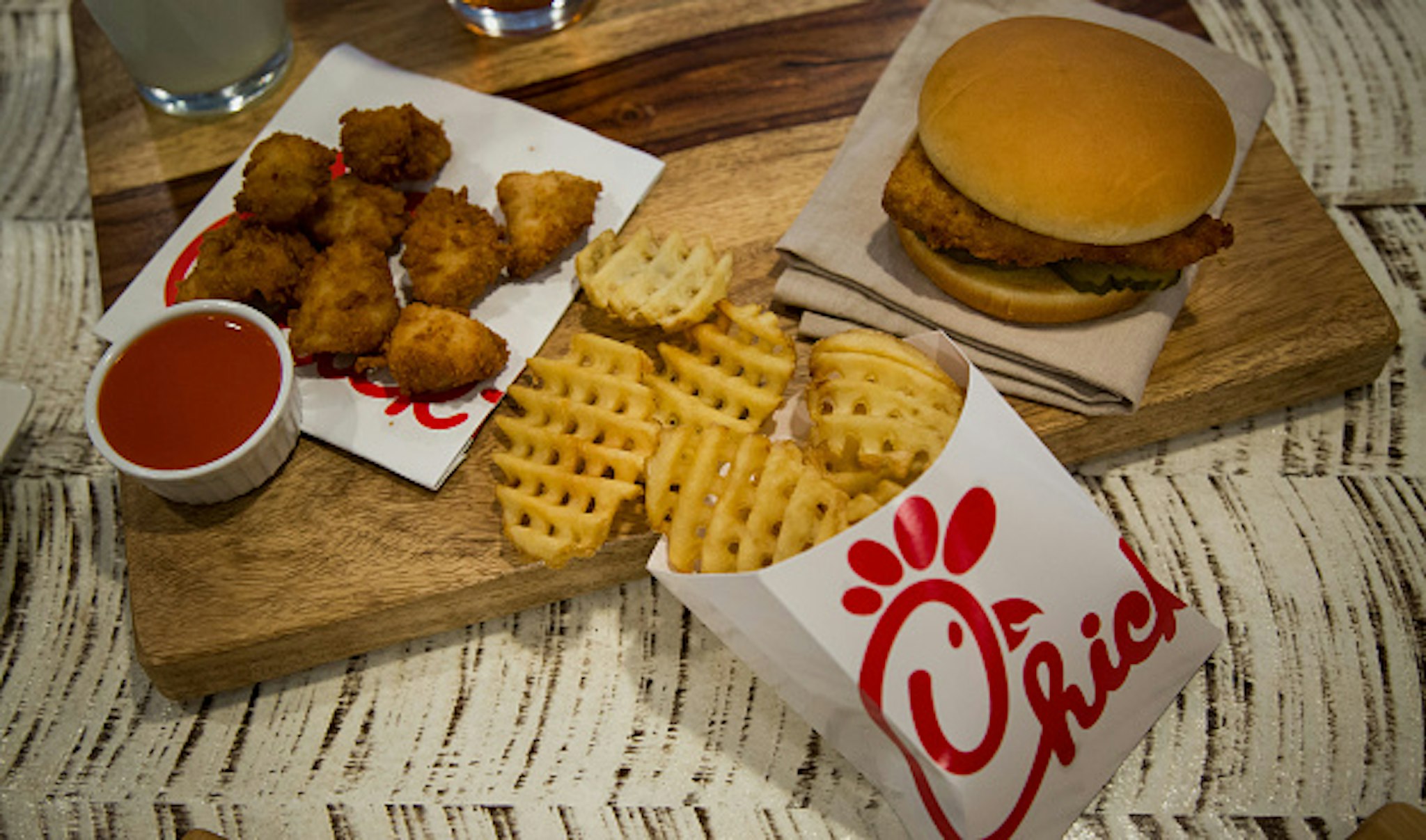 Chicken nuggets, french fries, and a fried chicken sandwich are arranged for a photograph during an event ahead of the grand opening for a Chick-fil-A restaurant in New York, U.S., on Friday, Oct. 2, 2015. Chick-fil-A, the Southern chicken-sandwich chain that has drawn both controversy and copycats over the years, has finally arrived in New York. The company will open a 5,000-square-foot (465-square-meter), three-level restaurant in Manhattan's Garment District that will be the chain's largest location in the nation.