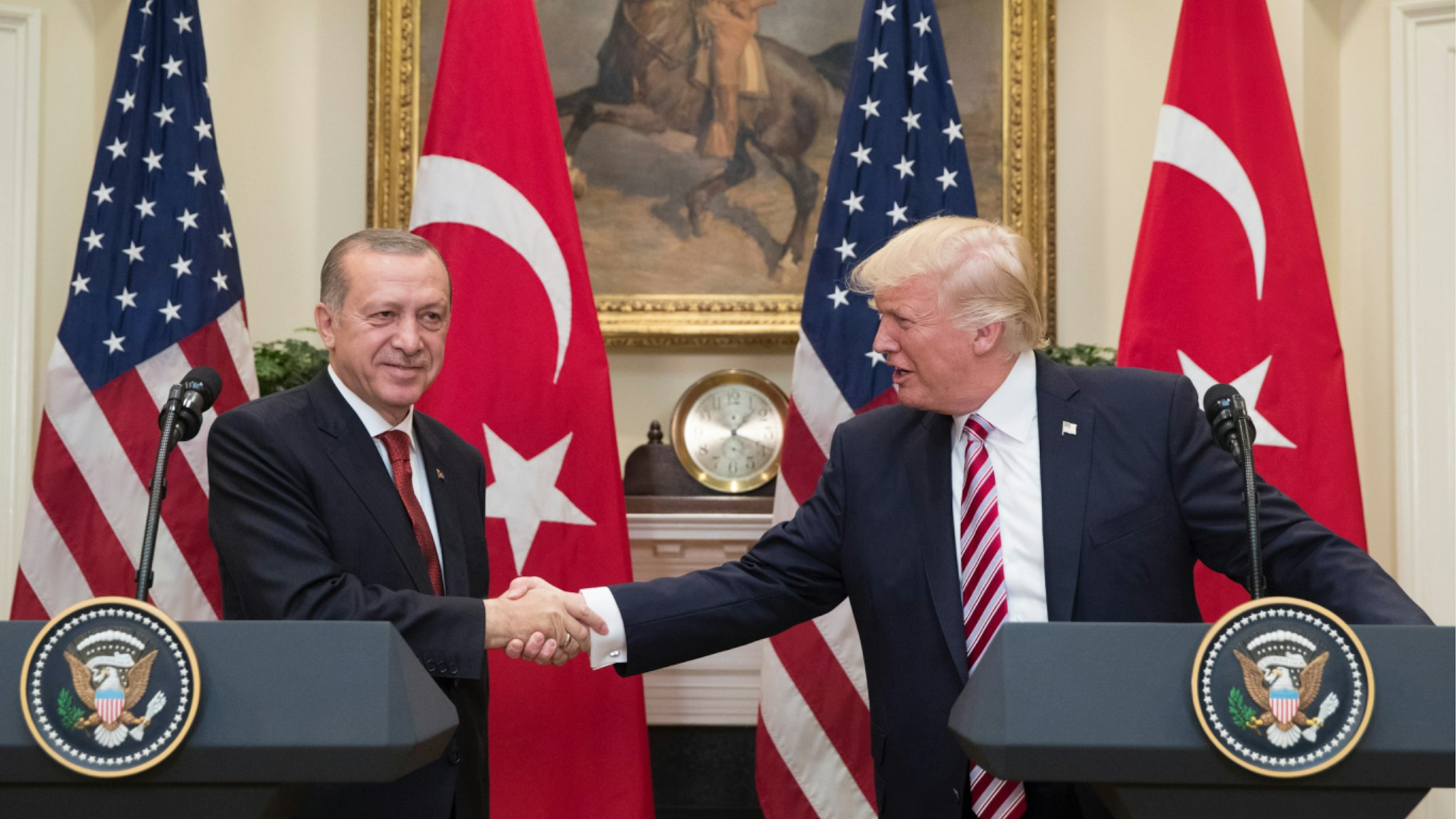 US President Donald Trump (R) shakes hands with President of Turkey Recep Tayyip Erdogan (L) in the Roosevelt Room where they issued a joint statement following their meeting at the White House on May 16, 2017 in Washington, DC.