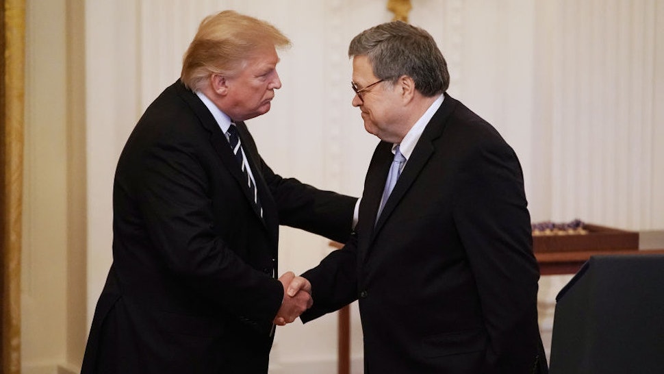 U.S. President Donald Trump (L) shakes hands with Attorney General William Barr before presenting the Public Safety Officer Medal of Valor during a ceremony in the East Room of the White House May 22, 2019 in Washington, DC. Comparable to the military's Medal of Honor, the Medal of Valor was established in 2000 by President Bill Clinton. (Photo by Chip Somodevilla/Getty Images)