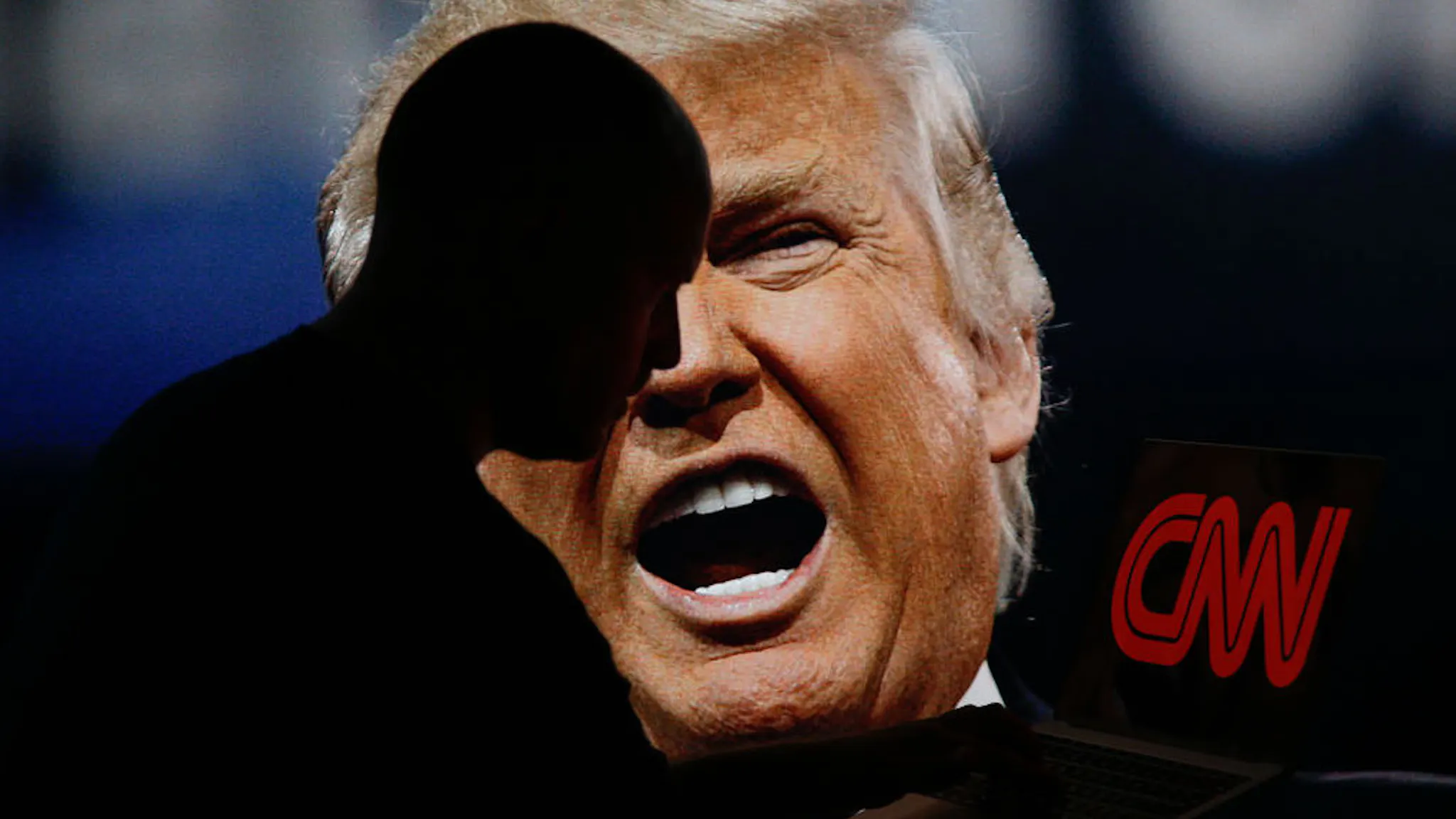 Donald Trump CNN A man is seen with a laptop depicting the CNN news network logo with Donald Trump appearing on a TV screen in the background in this photo illustration on 2 July, 2017. (Photo by Jaap Arriens/NurPhoto)