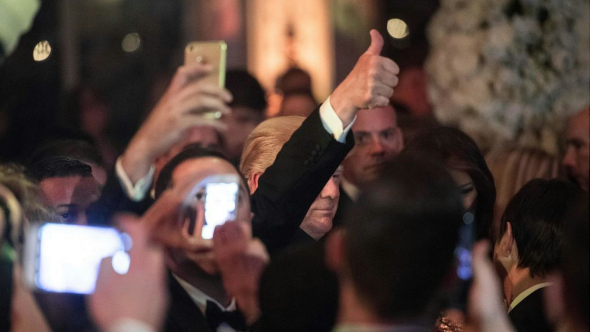 US President Donald Trump arrives at a new year's party at Trump's Mar-a-Lago resort in Palm Beach, Florida, on December 31, 2017.