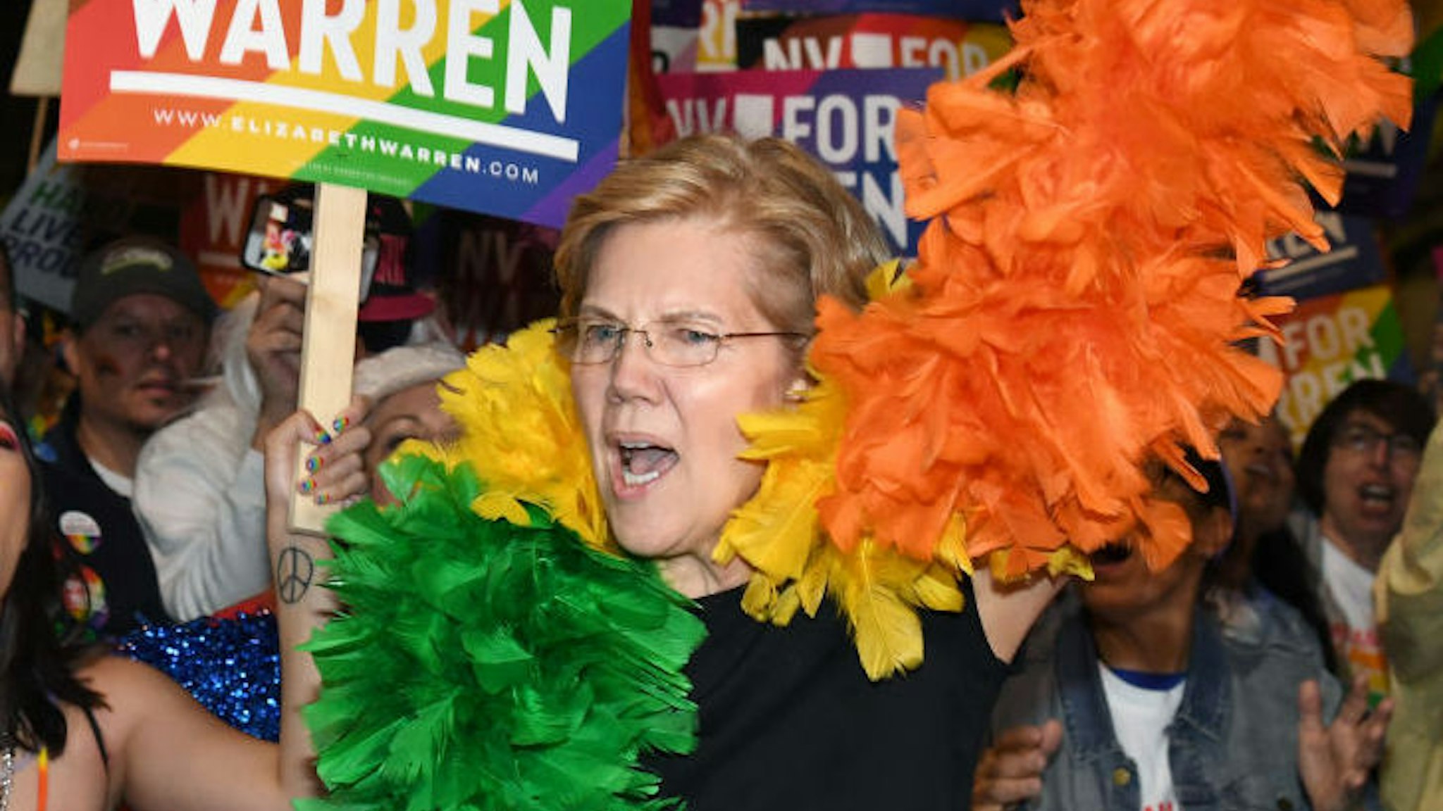 Democratic presidential candidate and U.S. Sen. Elizabeth Warren (D-MA) (R) marches with supporters in the Southern Nevada Association of Pride Inc. 22nd annual PRIDE Night Parade on October 11, 2019 in Las Vegas, Nevada. Recent national presidential primary polls show Warren in a tight race for the top spot with former U.S. Vice President Joe Biden for the 2020 Democratic Party nomination heading into Tuesday's debate. (Photo by Ethan Miller/Getty Images)