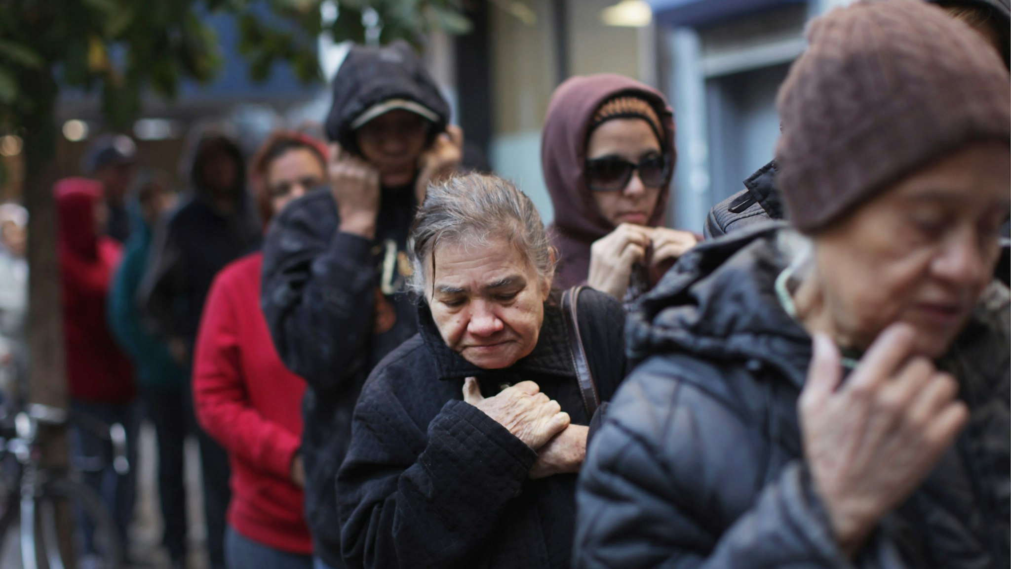 People wait in line to receive free milk from the Milk from the Heart program which makes weekly deliveries to Washington Heights and 12 other locations in Manhattan and the Bronx on October 6, 2011 in New York City.