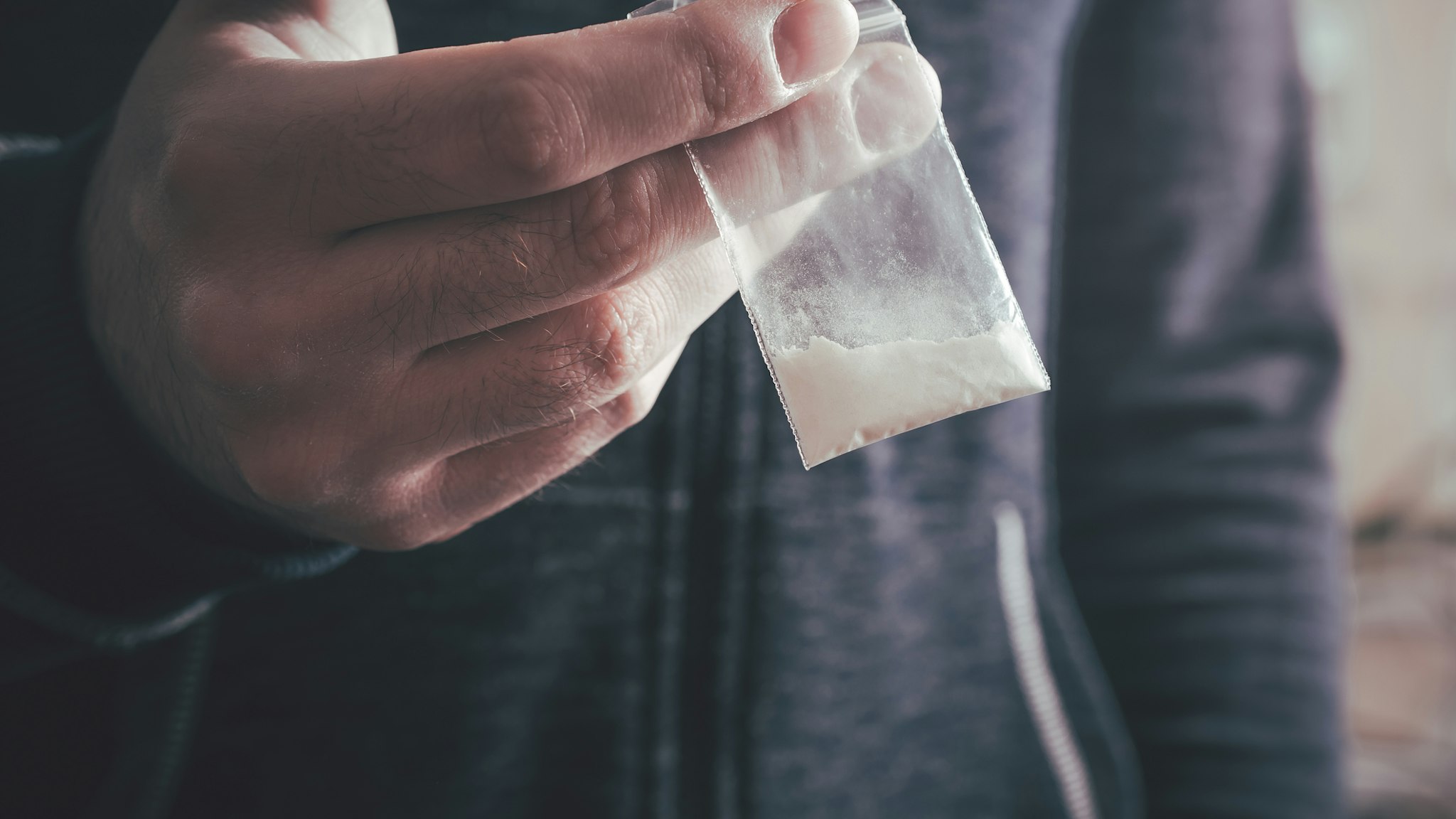 Midsection Of Man Holding Cocaine - stock photo