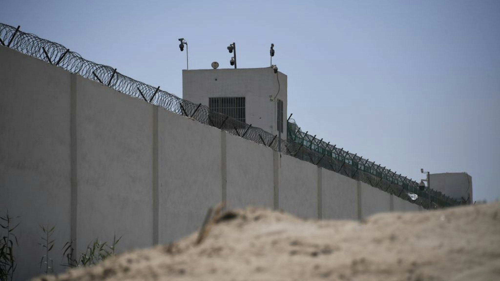 This photo taken on May 31, 2019 shows the outer wall of a complex which includes what is believed to be a re-education camp where mostly Muslim ethnic minorities are detained, on the outskirts of Hotan, in China's northwestern Xinjiang region.