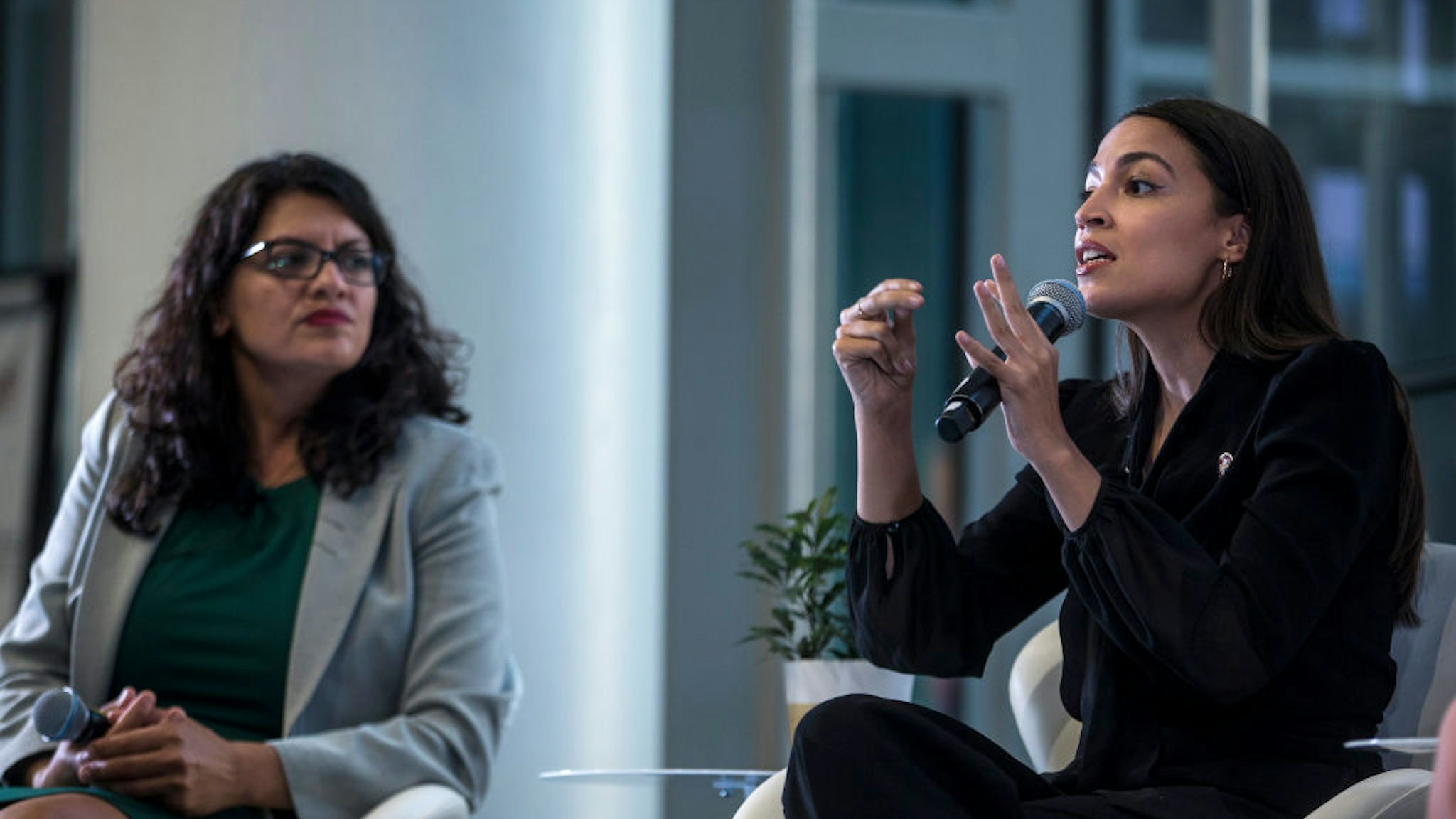 ep. Alexandria Ocasio-Cortez (D-NY) speaks during a town hall hosted by the NAACP on September 11, 2019 in Washington, DC. Also pictured is Rep. Rashida Tlaib (D-MI). The congresswomen talked about their backgrounds and how they were disruptors who “challenged conventional wisdom and assumptions” about how to get elected, among other topics.