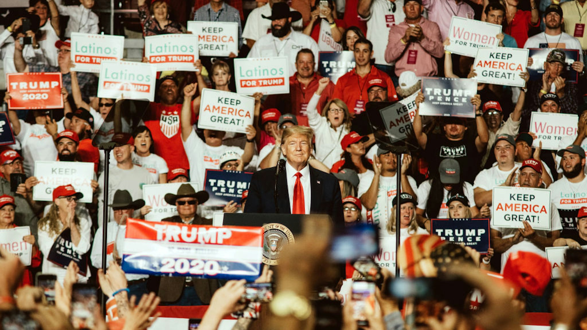U.S. President Donald Trump, center, smiles during a rally in Rio Rancho, New Mexico, U.S., on Monday, Sept. 16, 2019.
