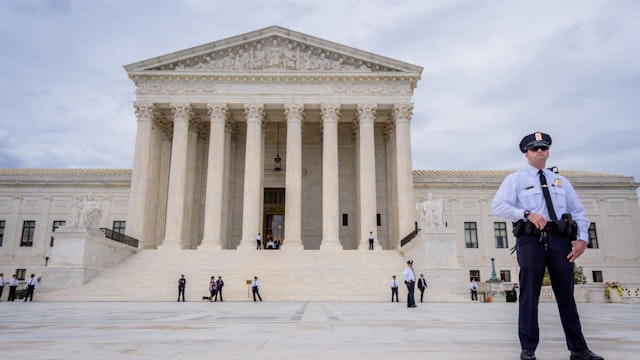 WASHINGTON DC, UNITED STATES - 2019/10/08: A police officer guarding outside the Supreme Court of the United States in Washington, DC.