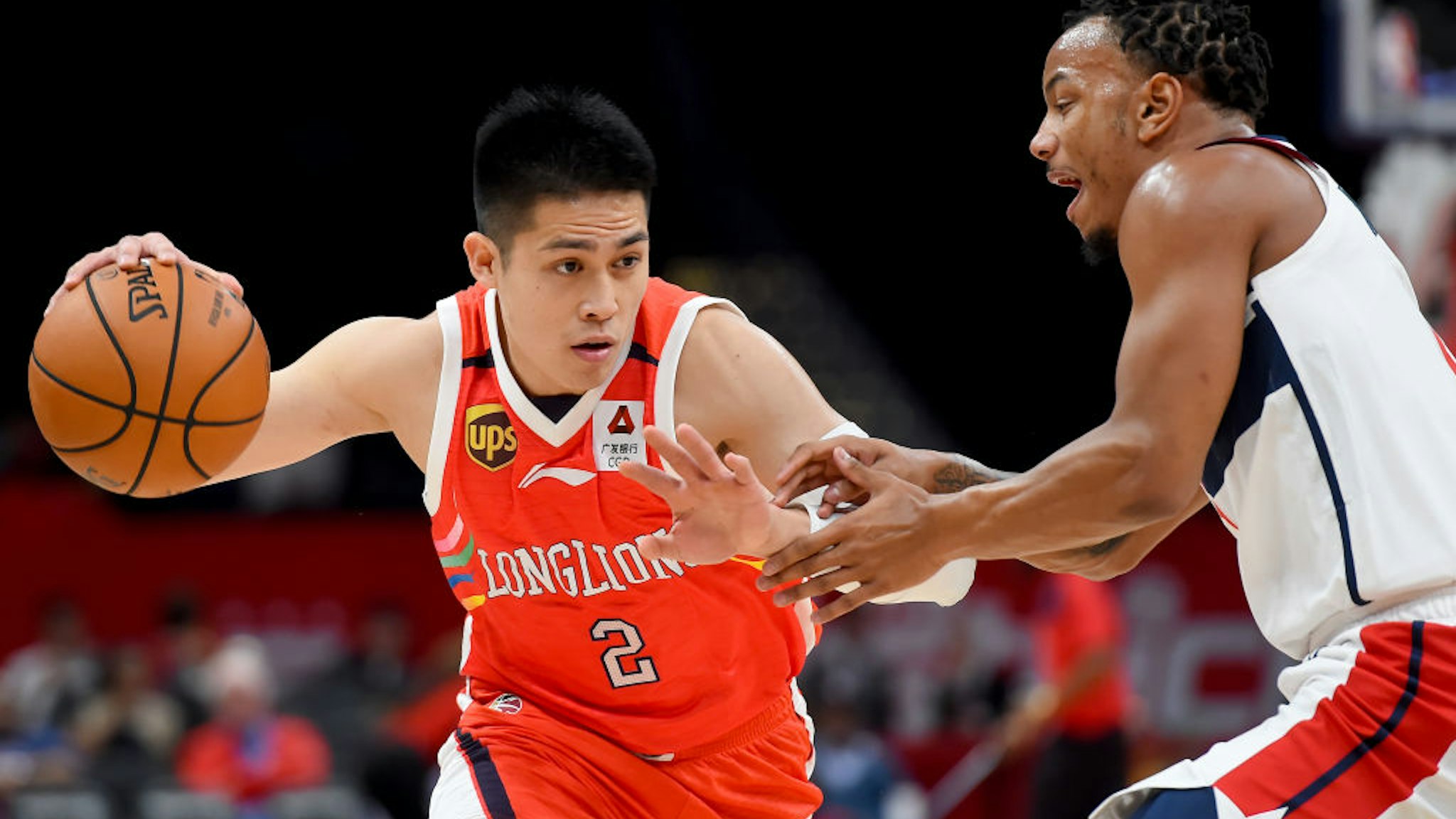 WASHINGTON, DC - OCTOBER 09: Ying-Chun Chen #2 of the Guangzhou Long-Lions drives against Justin Robinson #5 of the Washington Wizards during the first half at Capital One Arena on October 9, 2019 in Washington, DC.