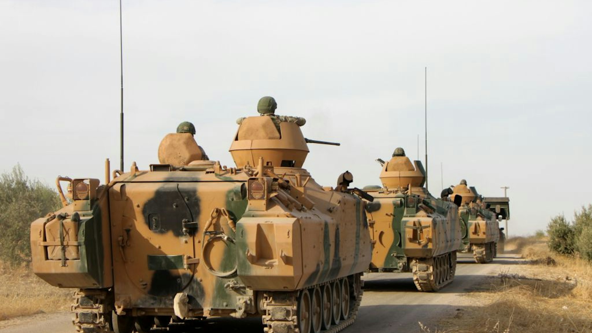 Turkish soldiers are trasported in armoured personnel carriers through the town of Tukhar, north of Syria's northern city of Manbij, on October 14, 2019, as Turkey and it's allies continues their assault on Kurdish-held border towns in northeastern Syria. - Turkey wants to create a roughly 30-kilometre (20-mile) buffer zone along its border to keep Kurdish forces at bay and also to send back some of the 3.6 million Syrian refugees it hosts.