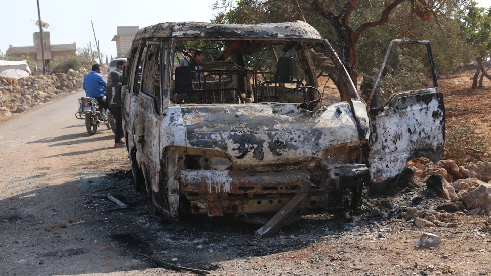 27 October 2019, Syria, Barisha: Syrians inspect a burnt vehicle at the site near the northwestern Syrian village of Barisha in the province of Idlib near the border with Turkey, after media reports said Islamic State (IS) leader Abu Bakr al-Baghdadi was believed to be killed in a US Special Forces raid in the same province. Photo: Mustafa Dahnon/dpa (Photo by Mustafa Dahnon/picture alliance via Getty Images)