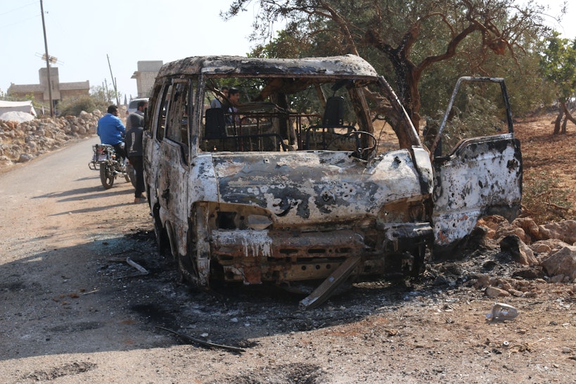 27 October 2019, Syria, Barisha: Syrians inspect a burnt vehicle at the site near the northwestern Syrian village of Barisha in the province of Idlib near the border with Turkey, after media reports said Islamic State (IS) leader Abu Bakr al-Baghdadi was believed to be killed in a US Special Forces raid in the same province. Photo: Mustafa Dahnon/dpa (Photo by Mustafa Dahnon/picture alliance via Getty Images)