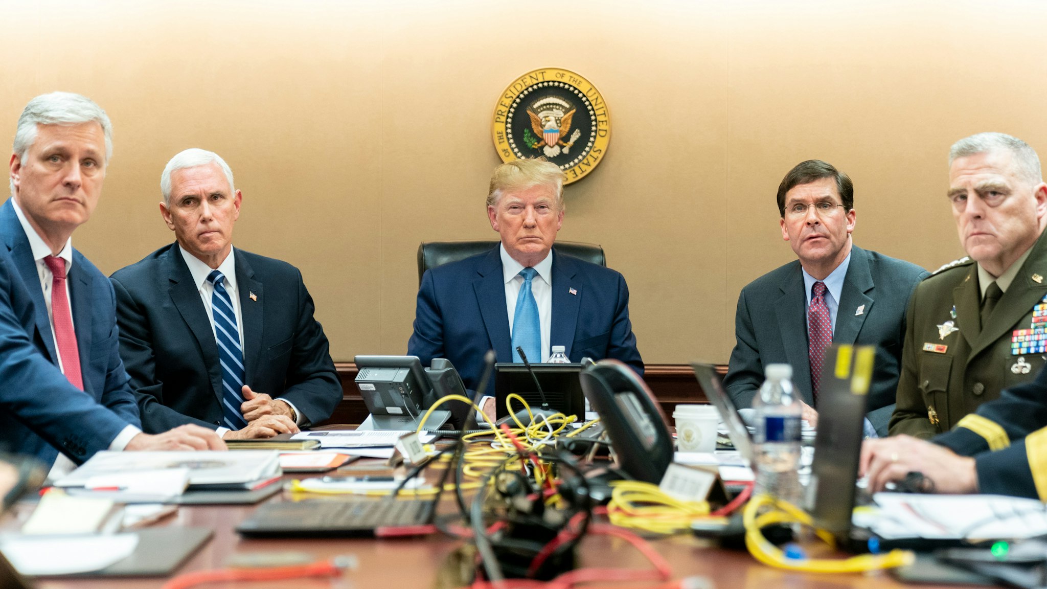In this handout photo provided by the White House, President Donald J. Trump is joined by Vice President Mike Pence (2nd L), National Security Advisor Robert O’Brien (L), Secretary of Defense Mark Esper (2nd R) and Chairman of the Joint Chiefs of Staff U.S. Army General Mark A. Milley in the Situation Room of the White House October 26, 2019 in Washington, DC. The President was monitoring developments as U.S. Special Operations forces close in on ISIS leader Abu Bakr al-Baghdadi’s compound in Syria with a mission to kill or capture the terrorist.