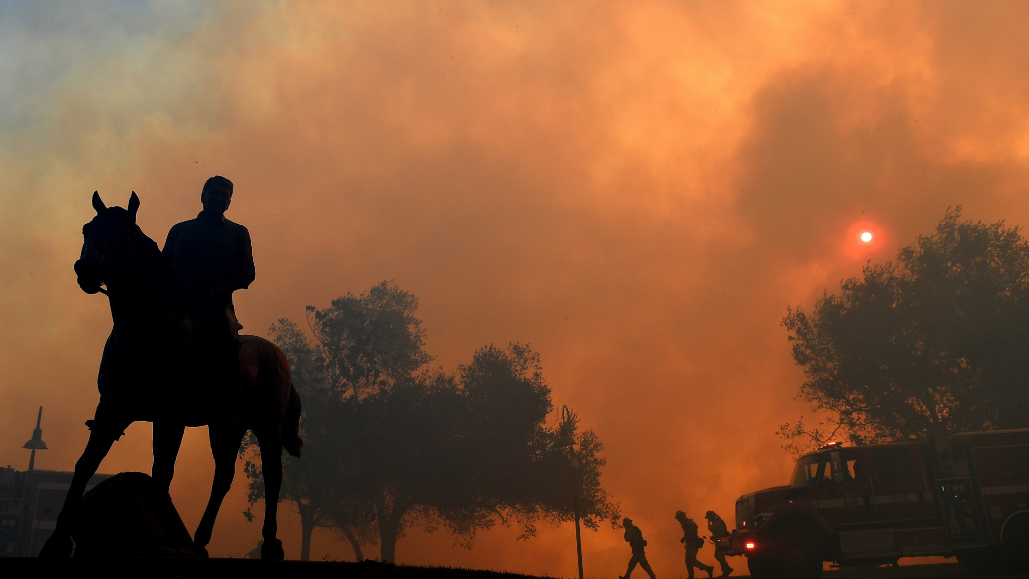 SIMI VALLEY, CALIFORNIA - OCTOBER 30: A statue of former U.S. President Ronald Reagan titled "Along The Trail" stands outside the Reagan Presidential Library as the Easy Fire burns on October 30, 2019 in Simi Valley, California. (Photo by Wally Skalij/Los Angeles Times via Getty Images)