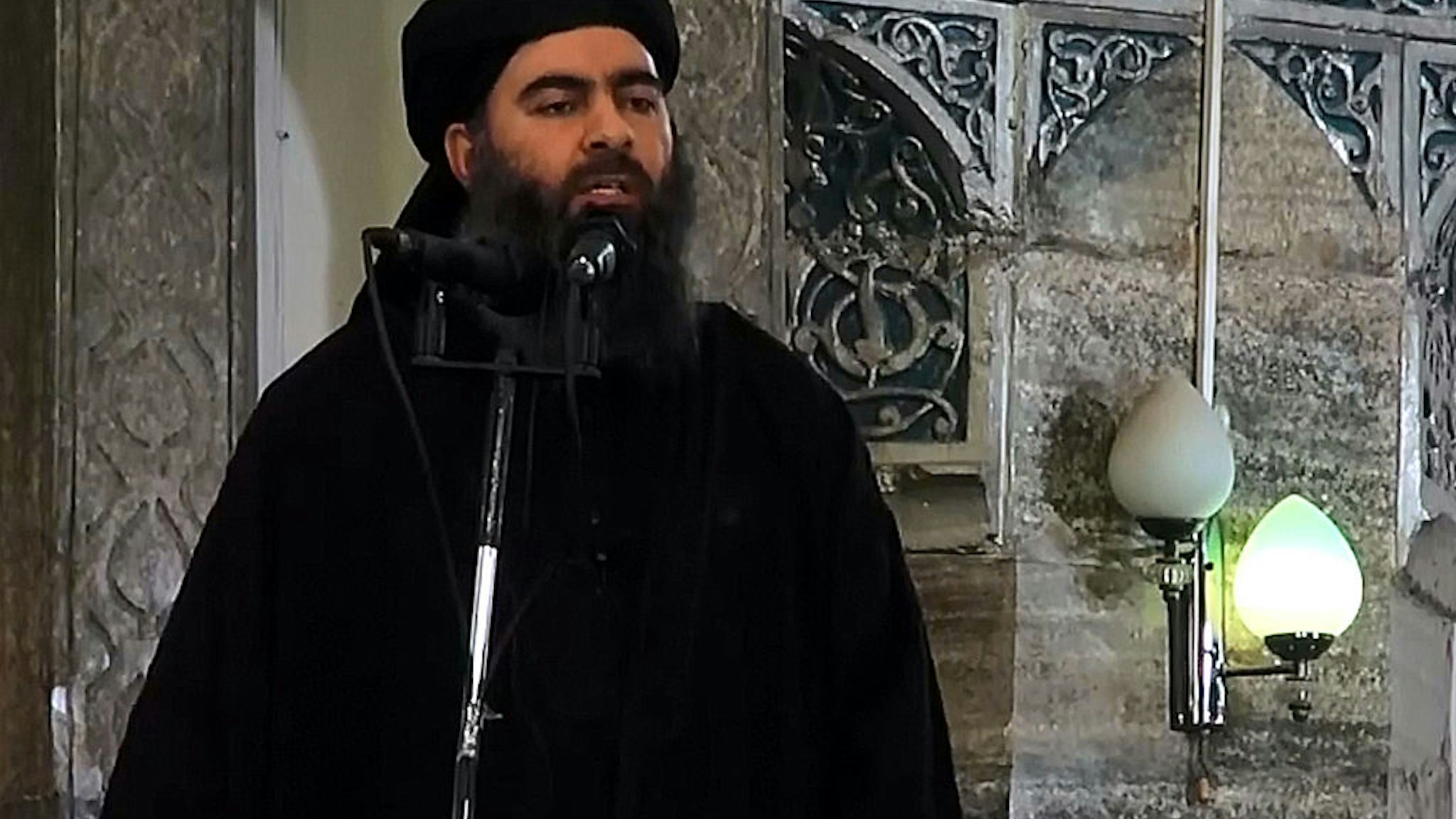 MOSUL, IRAQ - JULY 5 : An image grab taken from a video released on July 5, 2014 by Al-Furqan Media shows alleged Islamic State of Iraq and the Levant (ISIL) leader Abu Bakr al-Baghdadi preaching during Friday prayer at a mosque in Mosul.
