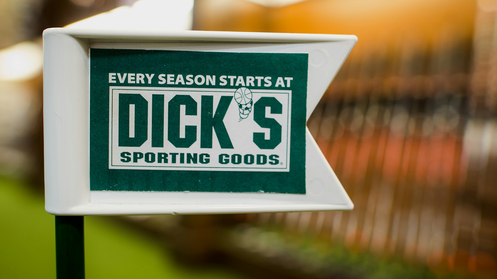 A golf flag stands on a practice green at a Dick's Sporting Goods Inc. store in West Nyack, New York, U.S., on Wednesday, May 21, 2014. Dick's Sporting Goods Inc. shares fell the most in more than a decade after weak sales of golfing and hunting gear crimped its profit forecast. Photographer: Craig Warga/Bloomberg via Getty Images
