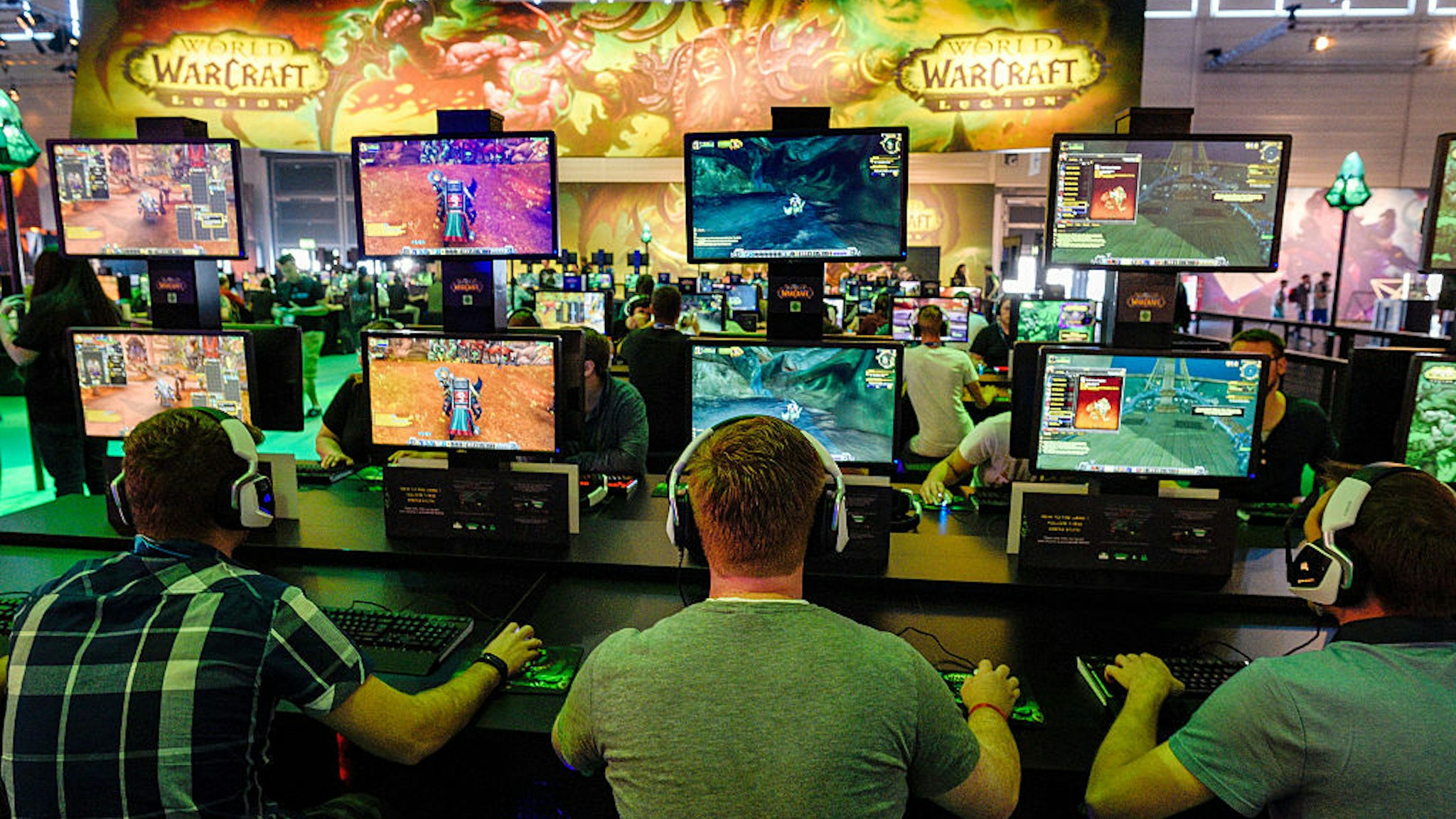 Visitors try out the massively multiplayer online role-playing game 'World Of Warcraft' at the Blizzard Entertainment stand at the Gamescom 2016 gaming trade fair during the media day on August 17, 2016 in Cologne, Germany.
