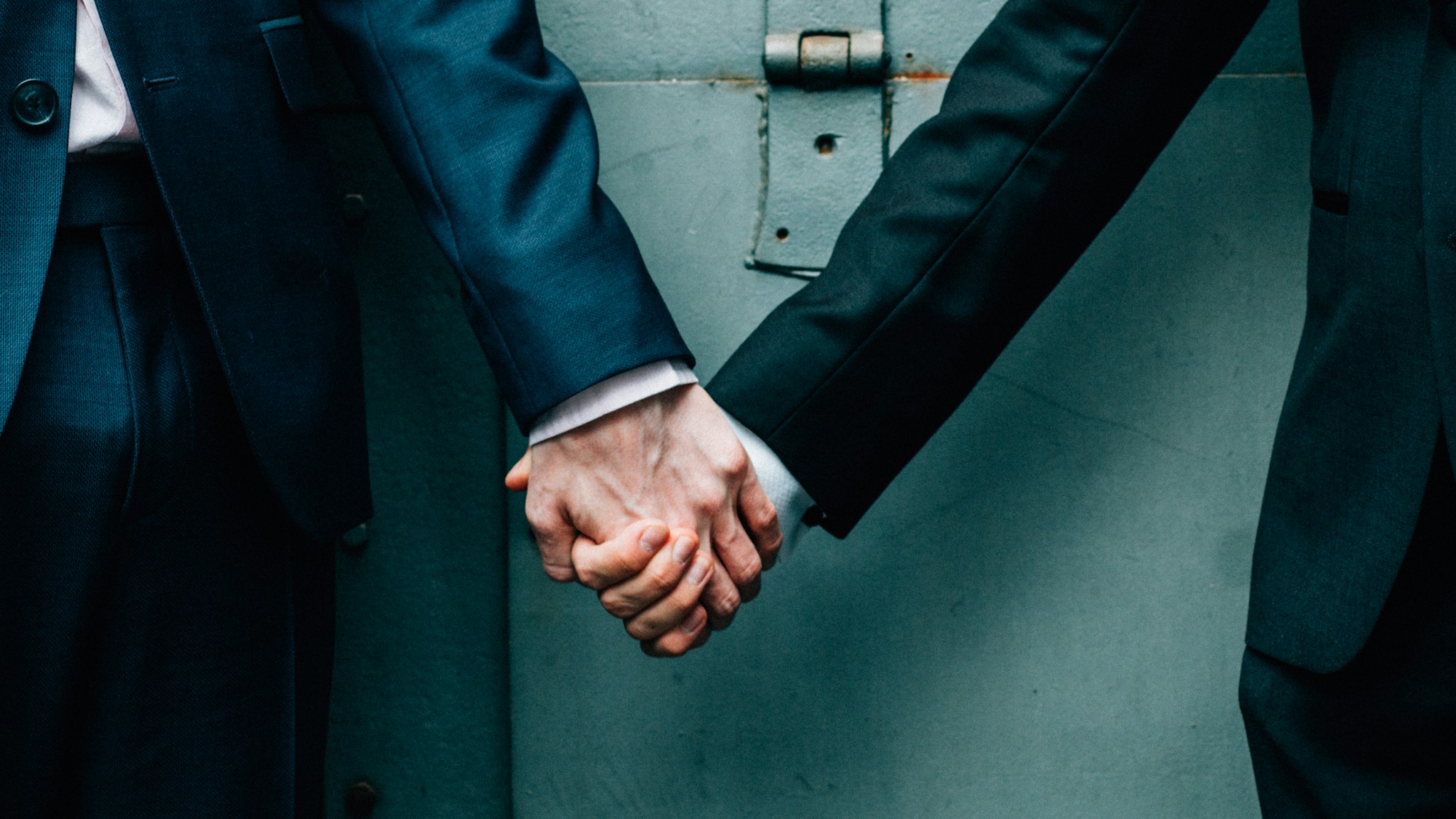 Same-sex couple holding hands