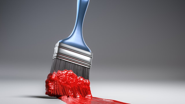 A blue handled paint brush sweeps across a white background with thick red paint