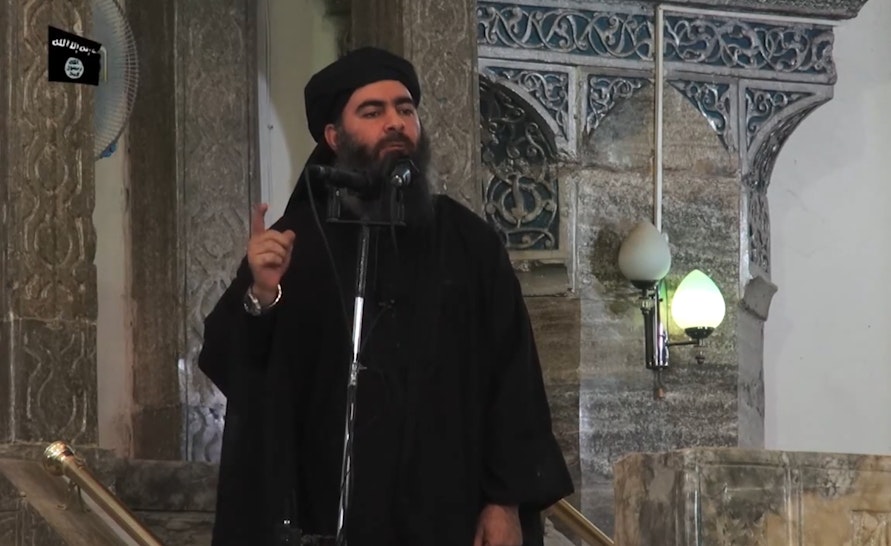 This July 5, 2014 photo shows an image grab taken from a propaganda video released by al-Furqan Media allegedly showing the leader of the Islamic State (IS) jihadist group, Abu Bakr al-Baghdadi, aka Caliph Ibrahim, adressing Muslim worshippers at a mosque in the militant-held northern Iraqi city of Mosul. Baghdadi, who on June 29 proclaimed a "caliphate" straddling Syria and Iraq, purportedly ordered all Muslims to obey him in the video released on social media. - In early 2014 the self-styled Islamic State entered the northern Syrian city of Raqqa, declaring it their capital and beginning a reign of terror marked by grisly public executions. Armed sharia police patrolled the streets as "enemies" of the regime were crucified or decapitated, their severed heads impaled on spikes in the city square. (Photo by - / AFP) (Photo by -/AFP via Getty Images)