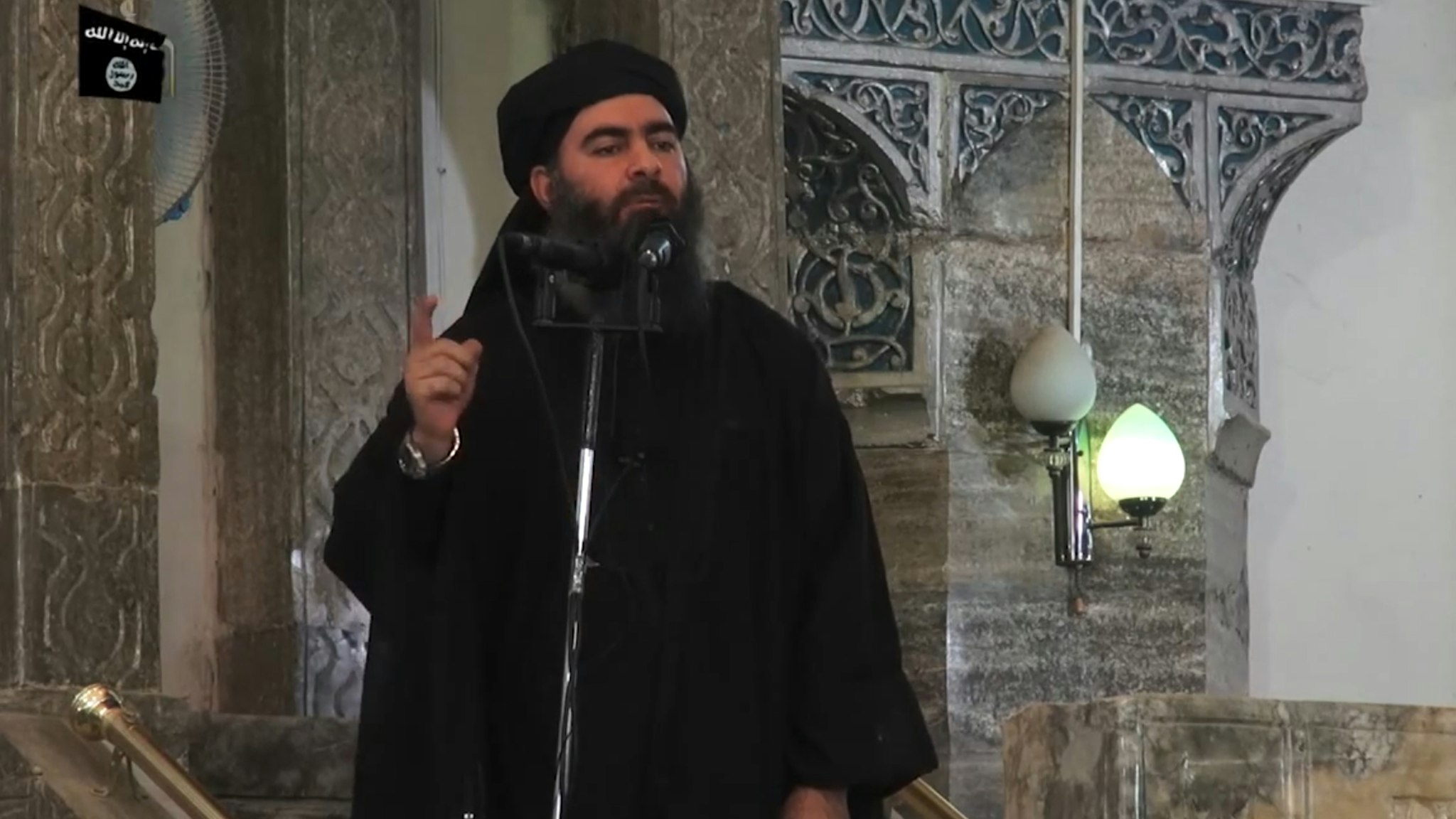 This July 5, 2014 photo shows an image grab taken from a propaganda video released by al-Furqan Media allegedly showing the leader of the Islamic State (IS) jihadist group, Abu Bakr al-Baghdadi, aka Caliph Ibrahim, adressing Muslim worshippers at a mosque in the militant-held northern Iraqi city of Mosul. Baghdadi, who on June 29 proclaimed a "caliphate" straddling Syria and Iraq, purportedly ordered all Muslims to obey him in the video released on social media. - In early 2014 the self-styled Islamic State entered the northern Syrian city of Raqqa, declaring it their capital and beginning a reign of terror marked by grisly public executions. Armed sharia police patrolled the streets as "enemies" of the regime were crucified or decapitated, their severed heads impaled on spikes in the city square. (Photo by - / AFP) (Photo by -/AFP via Getty Images)