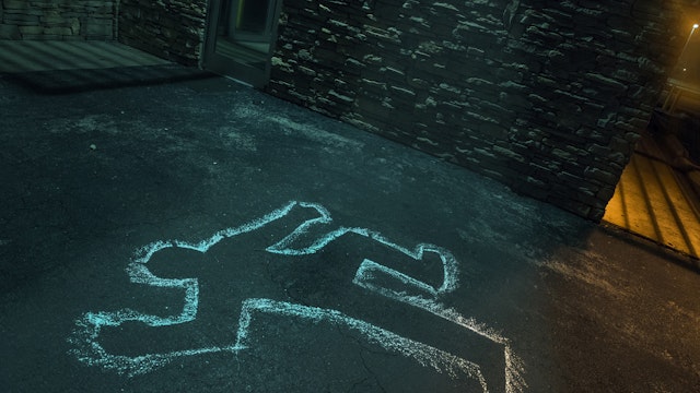 Chalk outline of body of victim on pavement - stock photo