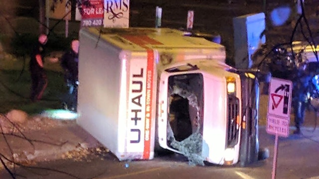 A rental truck lies on its side in Edmonton, Canada, on October 1, 2017, after a high speed chase. Canadian police arrested a man early Sunday suspected of stabbing an officer and injuring four pedestrians in a series of violent incidents being investigated as an "act of terrorism."