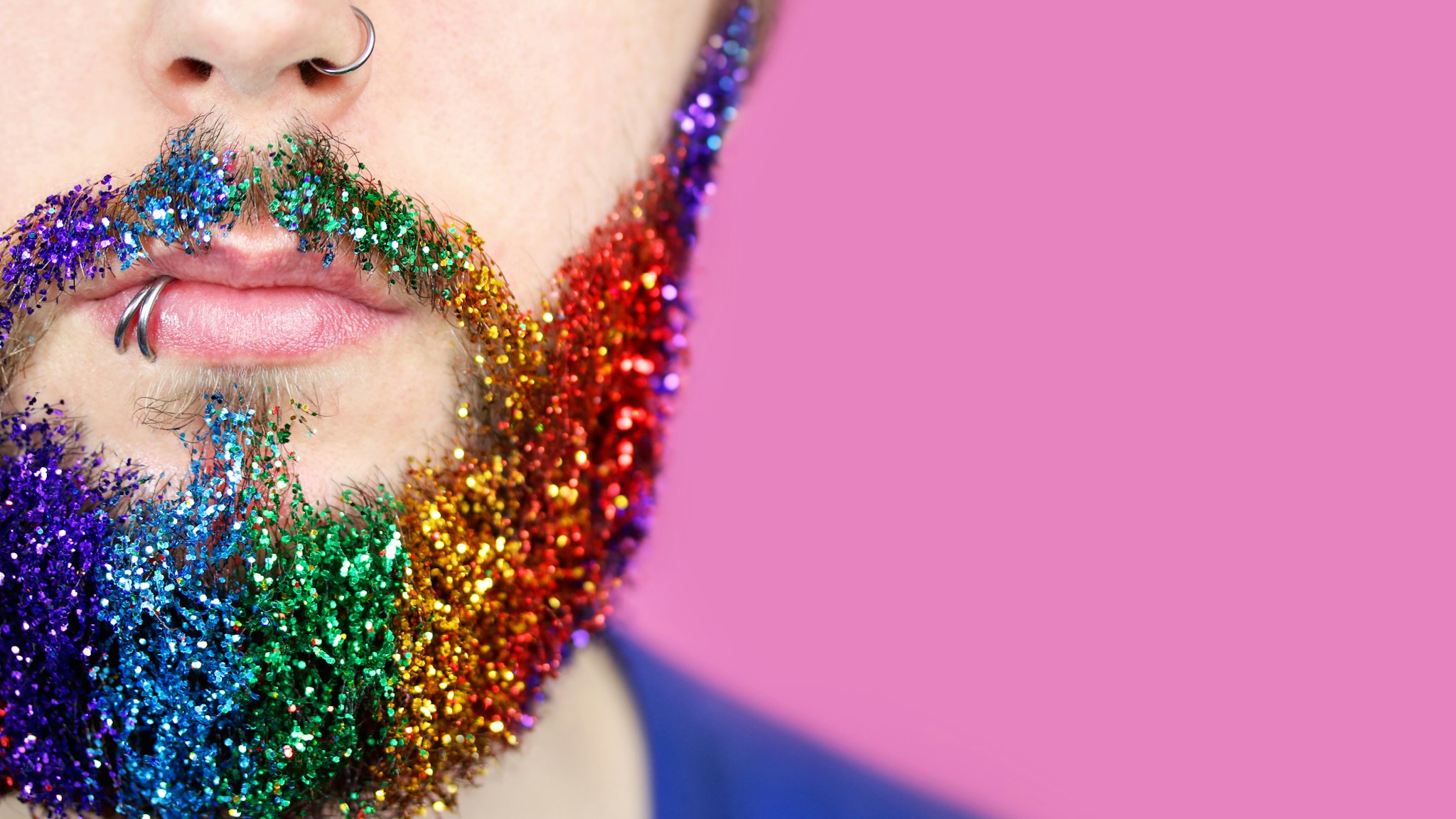 gay pride man with rainbow glitter beard - stock photo