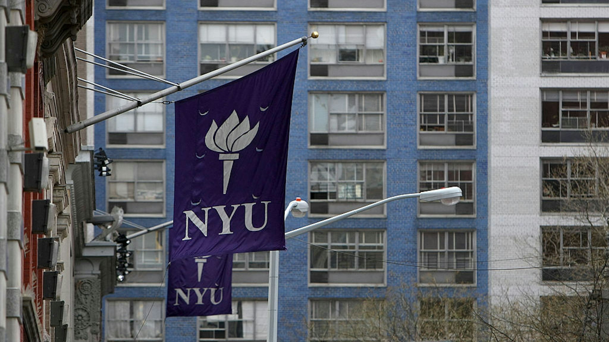 New York University banners hang from a building in New York, U.S., on Monday, April 5, 2010. New York University will face financial hurdles and a fight with Greenwich Village preservationists as it tries to take over more space and compete harder with uptown rival Columbia University.