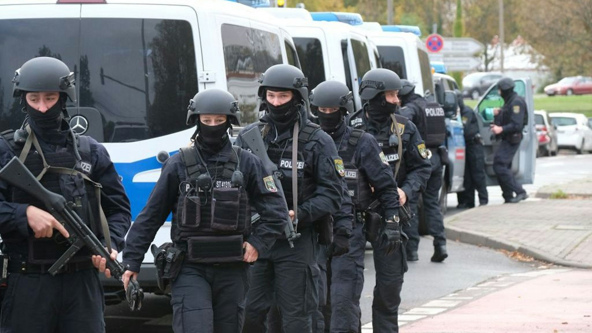 Policemen walk through a street close to the site of a shooting in Halle an der Saale, eastern Germany, on October 9, 2019. - At least two people were killed in a shooting on a street in the German city of Halle, police said, adding that the perpetrators were on the run. "Early indications show that two people were killed in Halle. Several shots were fired. The suspected perpetrators fled in a car," said police on Twitter, urging residents in the area to stay indoors. (Photo by Sebastian Willnow / dpa / AFP) / Germany OUT (Photo by SEBASTIAN WILLNOW/dpa/AFP via Getty Images)