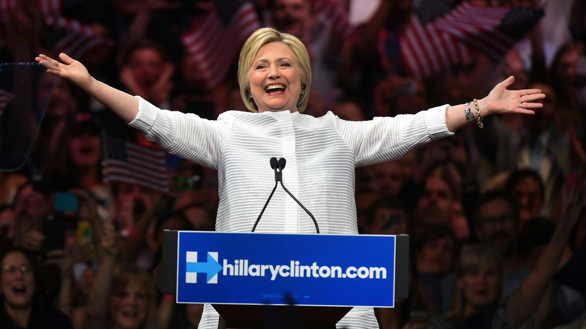 Democratic presidential candidate Hillary Clinton acknowledges celebratory cheers from the crowd during her primary night event at the Duggal Greenhouse, Brooklyn Navy Yard, June 7, 2016 in New York. Hillary Clinton hailed a historical "milestone" for women as she claimed victory over rival Bernie Sanders in the Democratic White House nomination race.