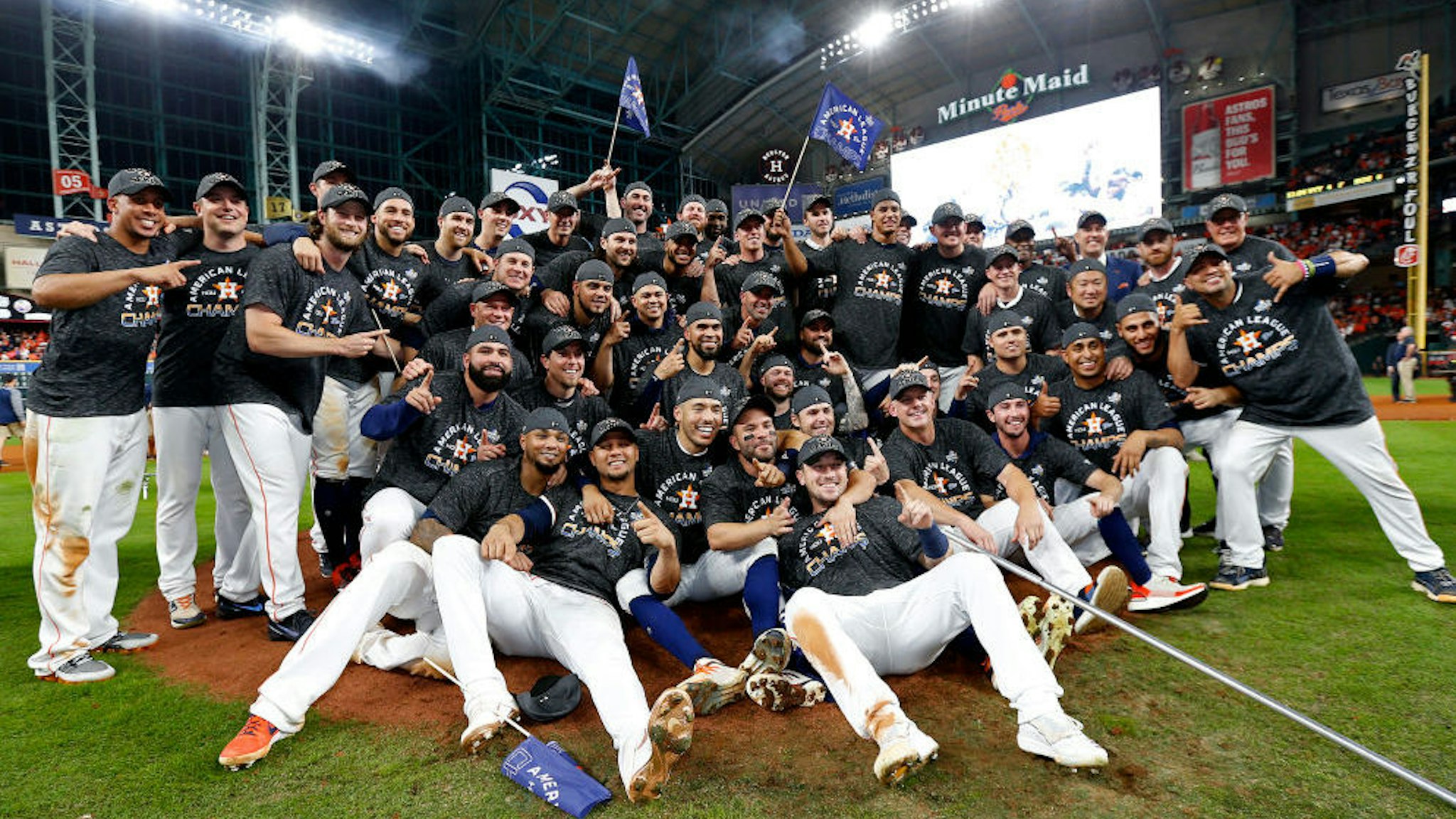The Houston Astros pose for a photo as they celebrate their 6-4 win against the New York Yankees in game six of the American League Championship Series at Minute Maid Park on October 19, 2019 in Houston, Texas. (Photo by Elsa/Getty Images)