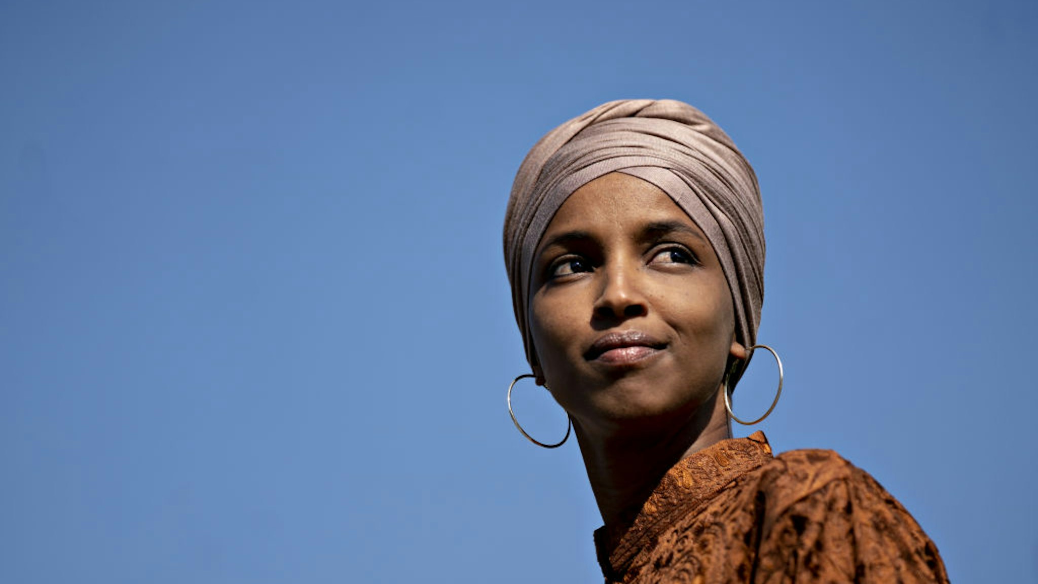 Ilhan Omar listens during a news conference on the Zero Waste Act