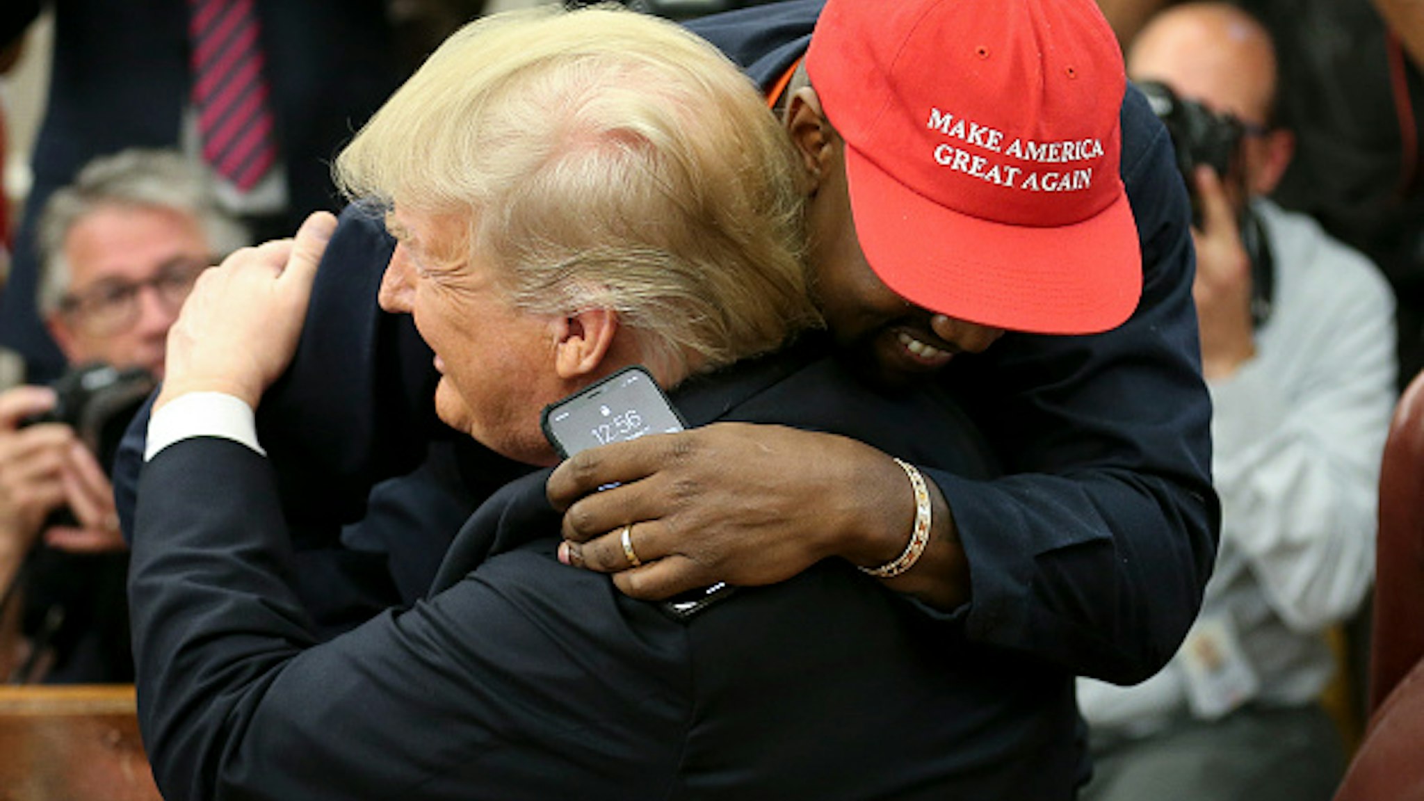 WASHINGTON, DC - OCTOBER 11: (AFP OUT) (EDITORS NOTE: Retransmission with alternate crop.) U.S. President Donald Trump hugs rapper Kanye West during a meeting in the Oval office of the White House on October 11, 2018 in Washington, DC.