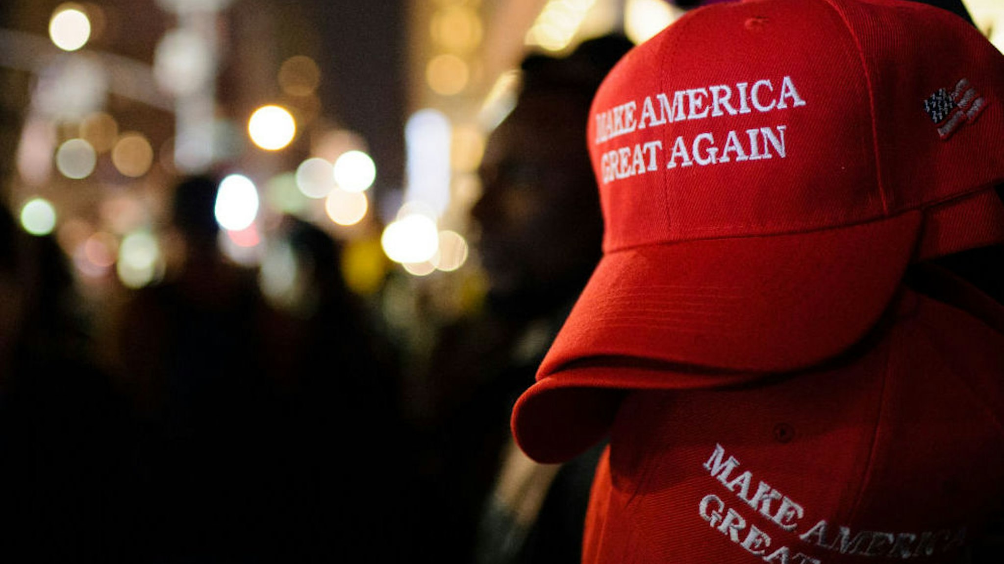 "Make America Great Again" red baseball caps, signature headwear of the Donald Trump campaign and its supporters, stand on sale on 6th Avenue in Midtown Manhattan in the second hour after Election Day as election results point to a shock Trump win. (Photo by David Cliff/SOPA Images/LightRocket via Getty Images)
