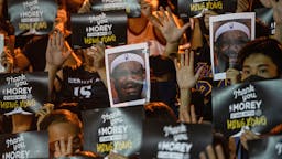 Protesters using Lebron James pictures as masks during the WAN CHAI, HONG KONG - 2019/10/15: Protesters using Lebron James pictures as masks during the demonstration. Hundreds of protesters gathered to express their anger about Lebron James's tweet and to show support to the General Manager of the Houston Rockets, Daryl Morey, and Adam Silver, Commissioner of the NBA, for defending freedom as a core value in NBA.
