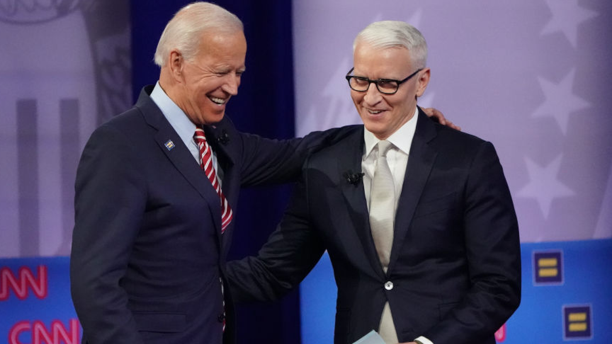 Democratic presidential candidate, former Vice President Joe Biden (L) embraces CNN moderator Anderson Cooper at the Human Rights Campaign Foundation and CNN presidential town hall, focused on LGBTQ issues, on October 10, 2019 in Los Angeles, California.