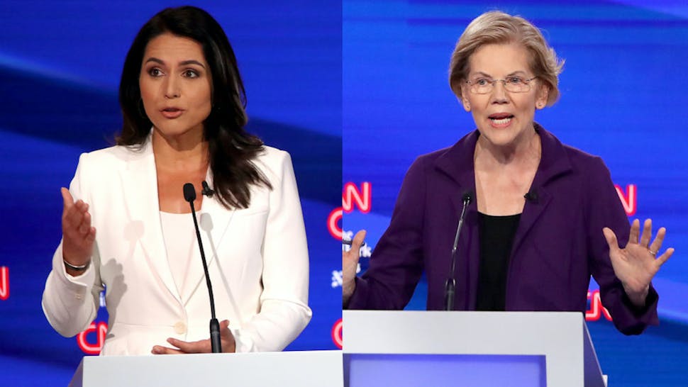 Tulsi Gabbard//Elizabeth Warren Rep. Tulsi Gabbard (D-HI) and Sen. Elizabeth Warren (D-MA) speak during the Democratic Presidential Debate at Otterbein University on October 15, 2019 in Westerville, Ohio.